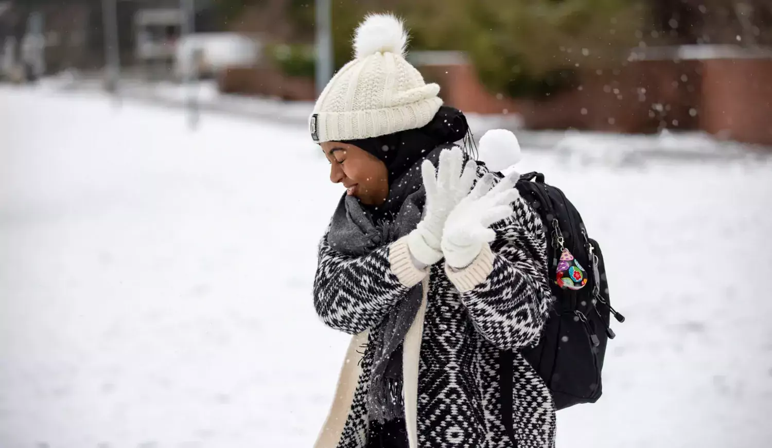 Student catching snow ball