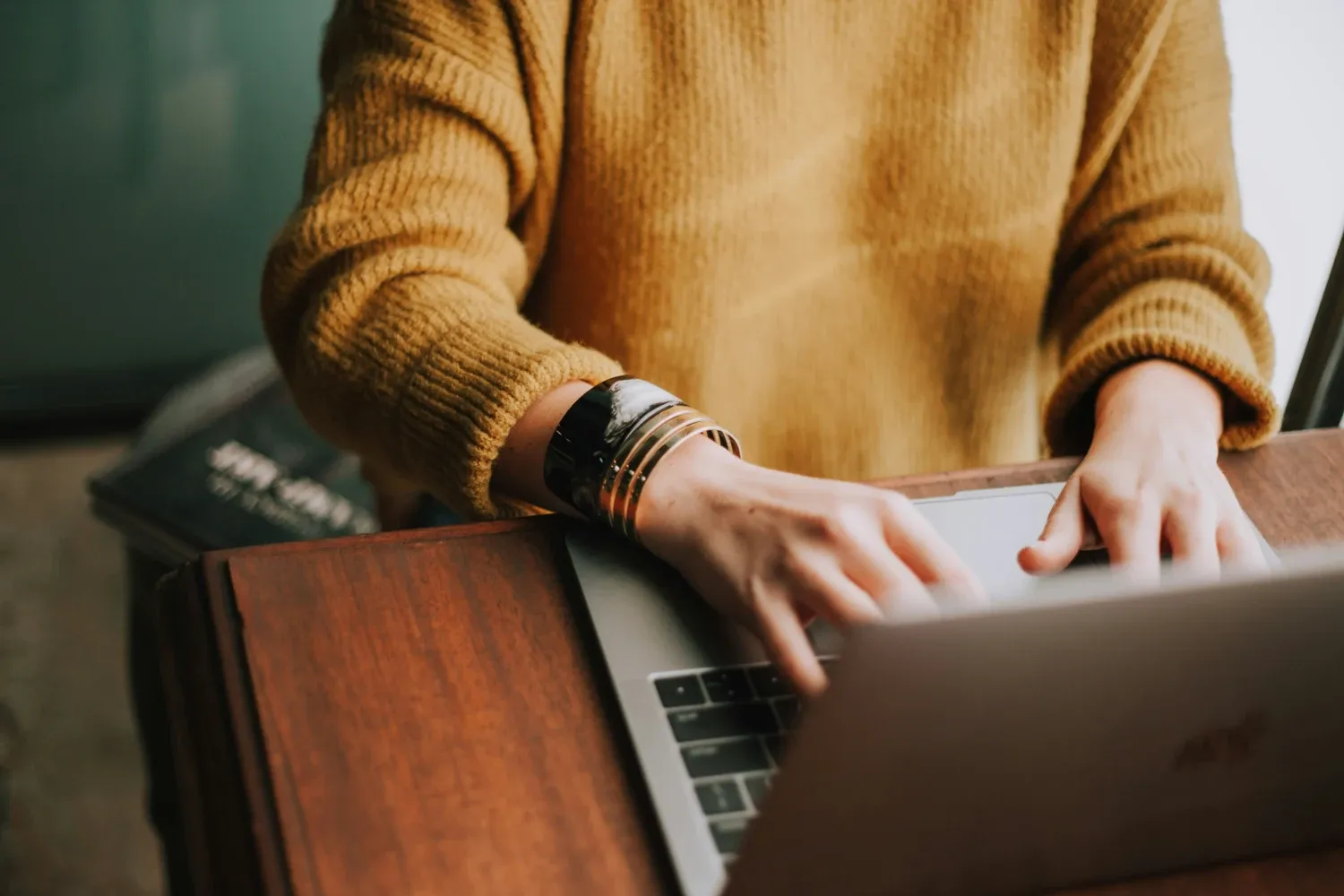 Two handstyping on a laptop