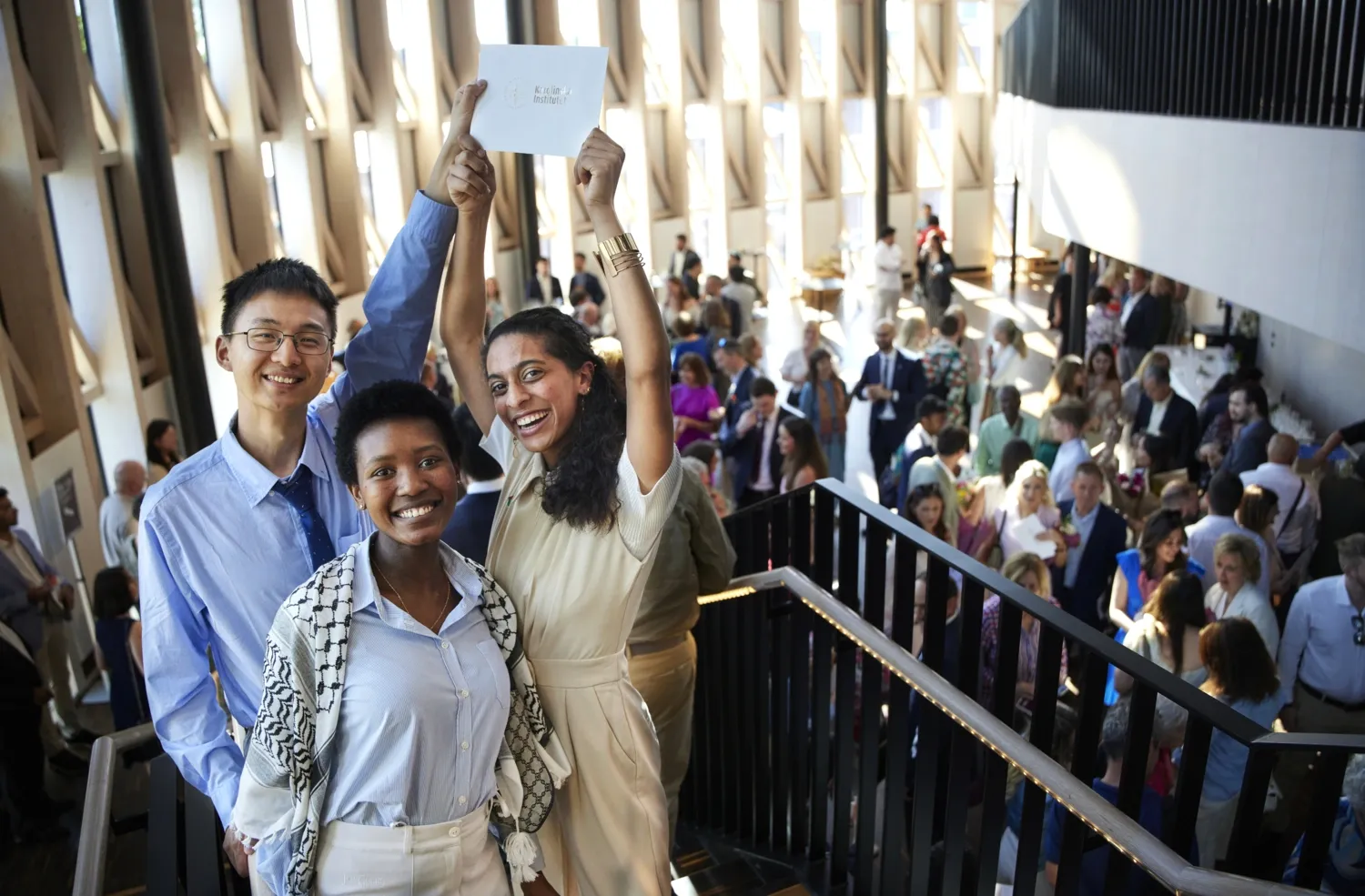 Portrait of three students inside of Aula Medica.