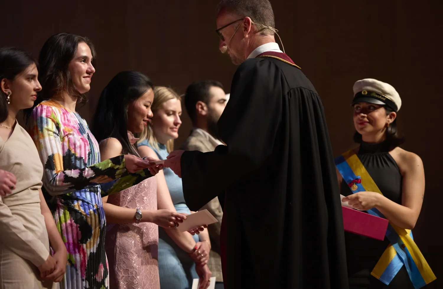 Rune Brautaset hands out envelopes to the examinees.