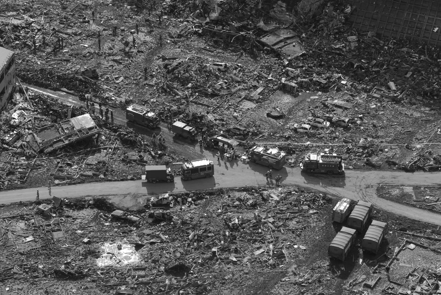 View over a disaster scene following with destroyed houses and rescue vehicles following an earth quake