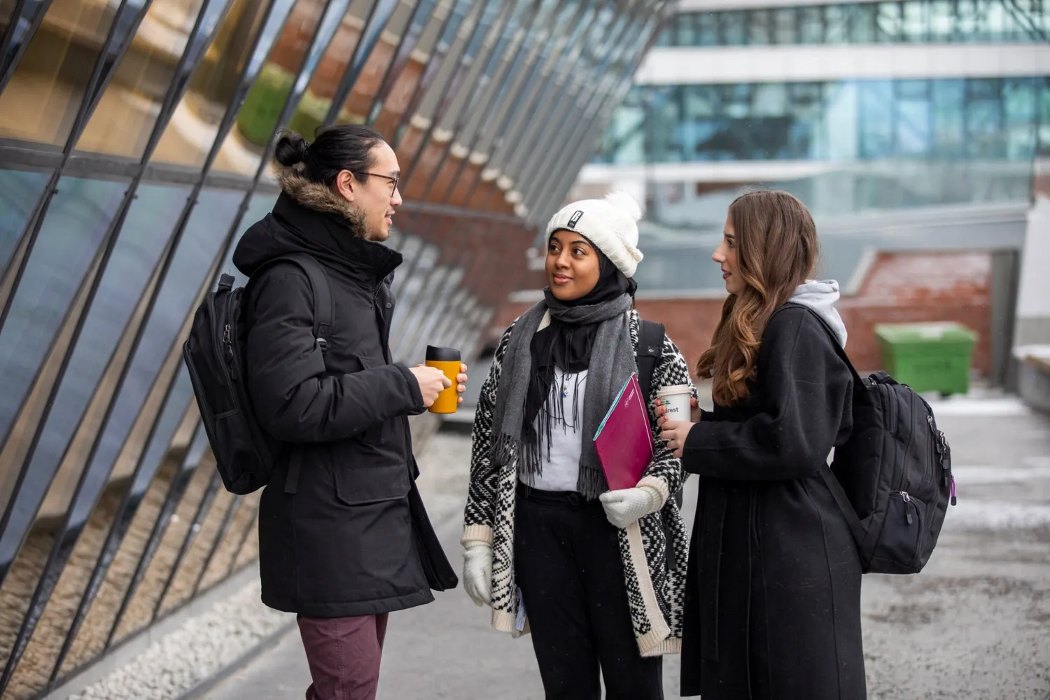 Students outdoors at campus Solna on a snowy winter's day.