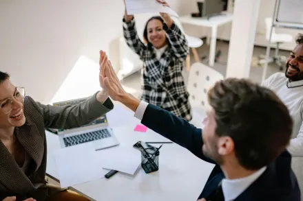 people highfiving in an office